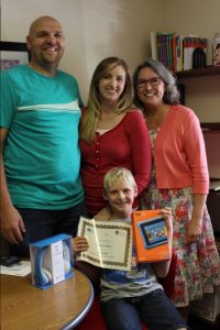 Dawson Willis (front center), with his tutor Carolee Hinterman (right), and his parents.